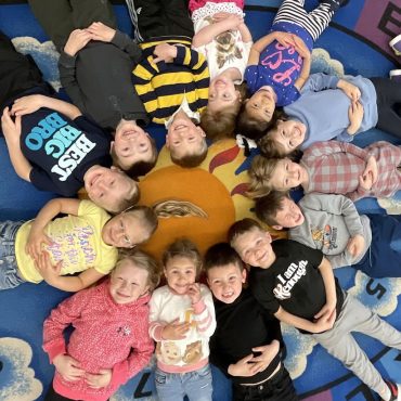 Preschooler at Salem Lutheran School in Minnesota laying in a circle enjoying school