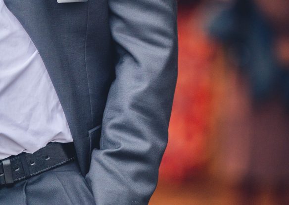 Vertical shot of a male event usher in a gray suit against a blurred background Vertical shot of a male event usher in a gray suit against a blurred background